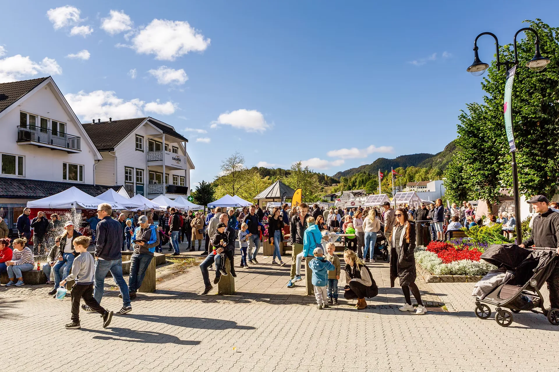 Folkeliv på torget i Liknes sentrum en solskinnsdag